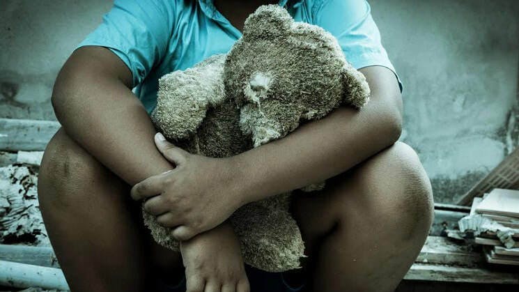 Child and teddy bear