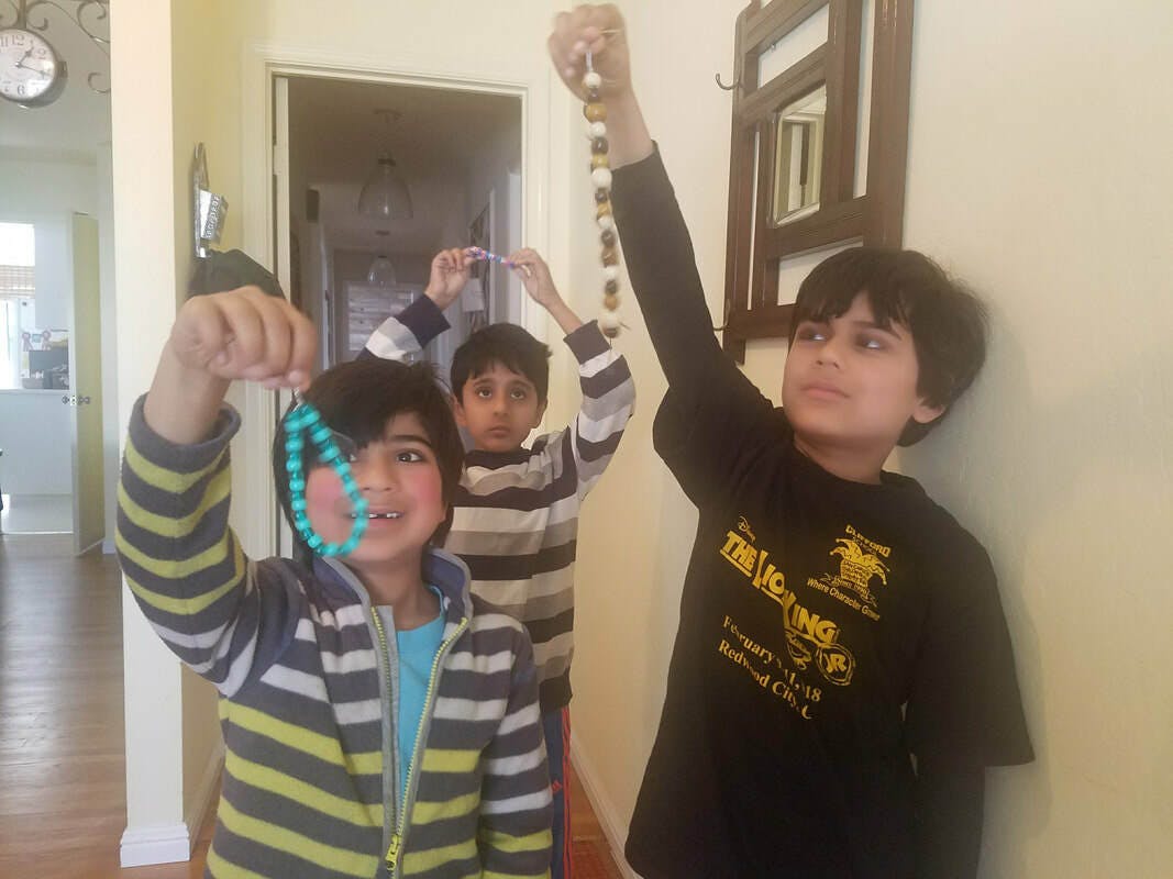 boys with prayer beads